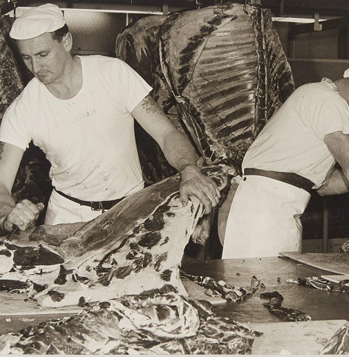 Australian butchers breaking down beef carcasses sometime in the 1900s.